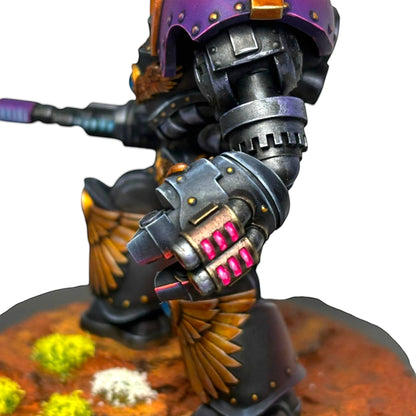 CT Miniatures UK Altus Spaciator miniature with purple helmet, black armor, gold wings, and glowing pink gems on its fist.