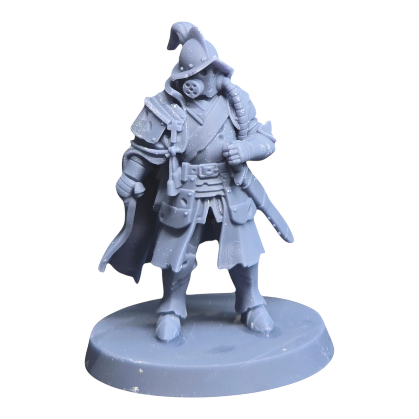 CT Miniatures UK Cortez's Comandante miniature, a grey resin figure with a helmet, gas mask, and cape, standing on a base.